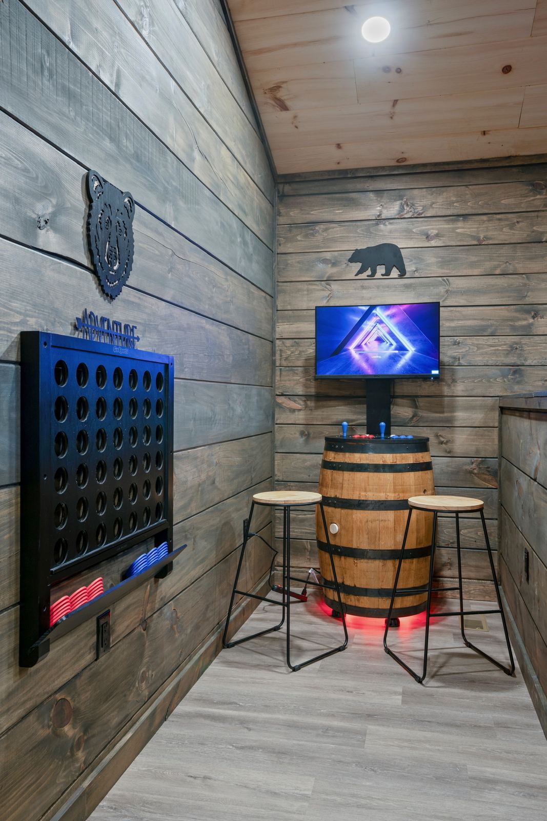 Barrel arcade cabinet with wall screen and giant Connect Four game