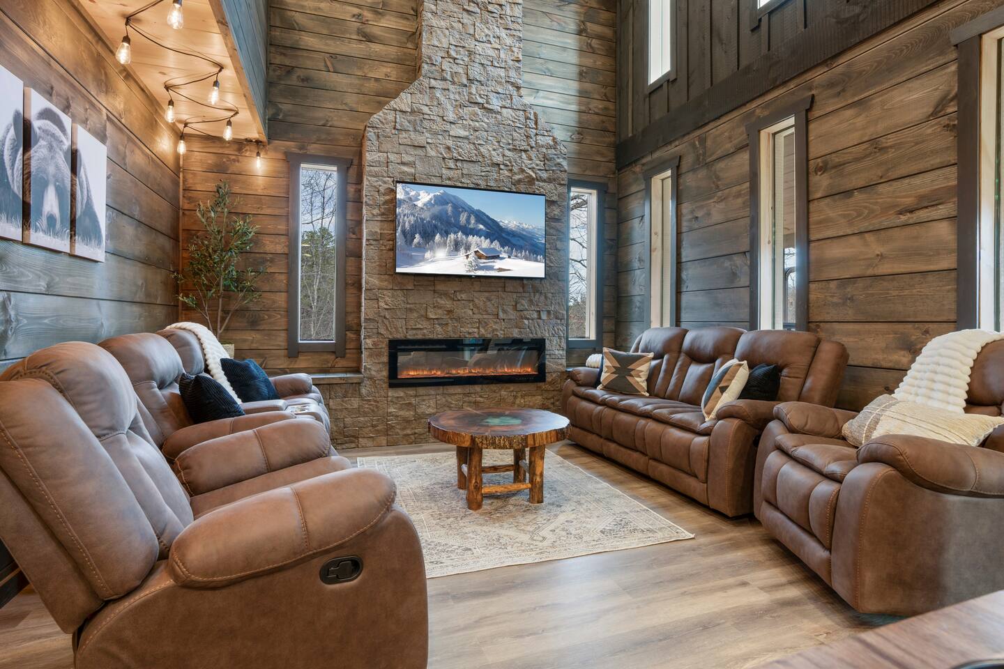 Living room with stone fireplace and mountain cabin seating